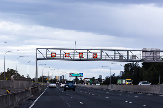 Overhead changeable digital 90 speed zone speed signs on metal structure above city road