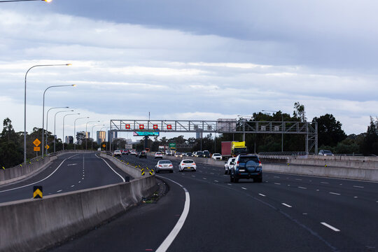 Overhead changeable digital 90 speed zone speed signs on metal structure above city road