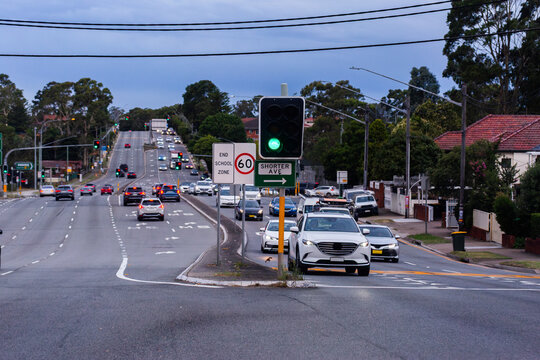 Sign at traffic light intersection to shorter avenue at dusk