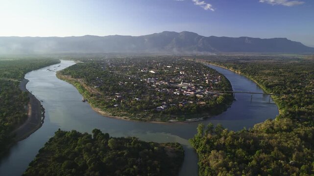 Aerial Drone View of Attapeu Town Surrounded by River Bend and Mountains, Laos