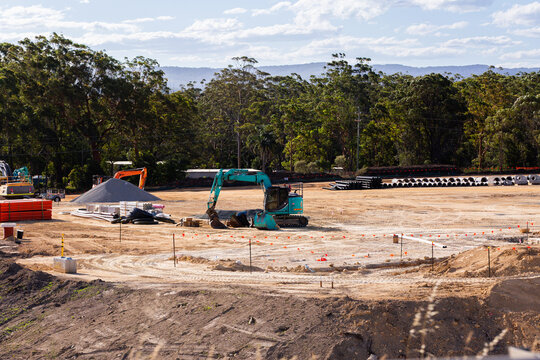 Excavator on worksite stopped on earthworks in cleared land