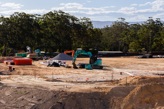 Excavator on worksite stopped on earthworks in cleared land