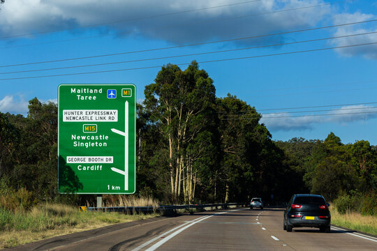 Green roadside sign with directions to hunter expressway Newcastle link road the M1 and M15