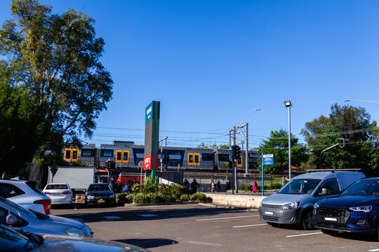 busy city train station platform in Narwee Sydney seen across road and carpark