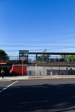 busy city train station platform in Narwee Sydney seen across road on sunny morning