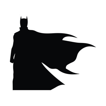 Batman standing heroically in iconic cape and mask