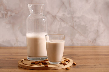 Almond milk in glass and bottle as dairy substitute lactose free beverage for food intolerance...