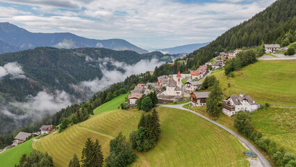 Aerial drone view of village, town Eores (Afers) near Bressanone (Brixen). Cloudy summer day. View...