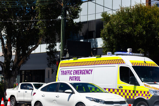 Traffic emergency patrol vehicle behind cars stopped on roadside in city