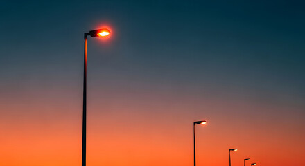 Streetlights at sunset with a vibrant orange glow