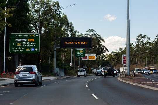 please slow down sign on overhead digital signage on road to castle hill A28