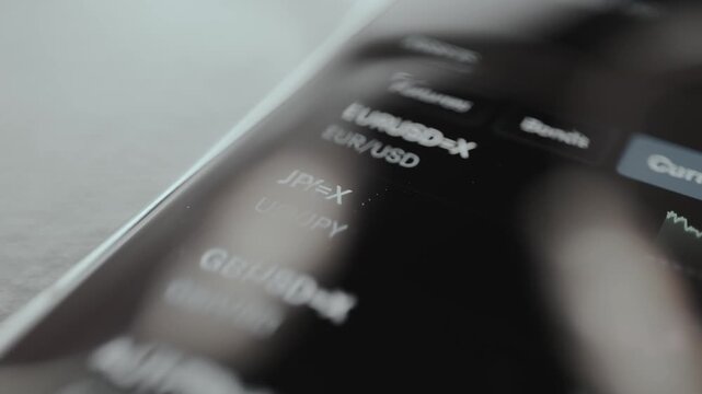 USD JPY financial trading pair from a mobile trading application, view through eyeglasses
