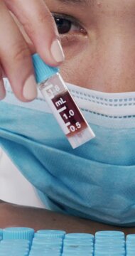 Blood sample, research and science with woman in laboratory for test, rh antigen group and enzyme formula. Healthcare, chemistry and medical with person in clinic genome discovery for biotechnology
