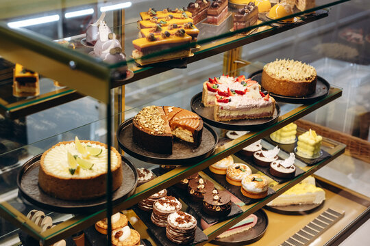 Assorted cakes and pastries displayed in a glass bakery case for dessert lovers and celebrations