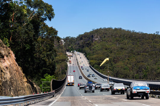wind sock between divided highway roads on bridge over windy valley