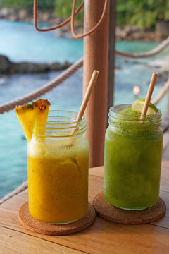 View of a cold pina colada cocktail in a tropical setting