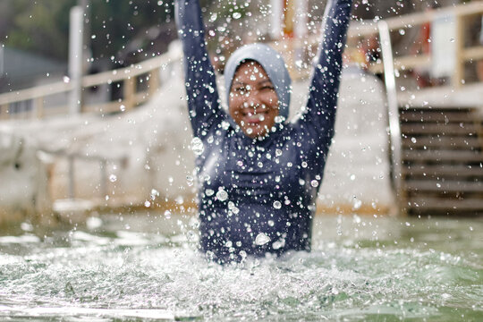 Filipina woman splashing water inside the tidal pool