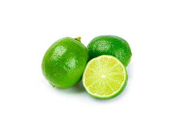 Fresh lime isolated on white background. Whole limes and slices in a bowl. Citrus. Vitamin C. Detox diet. Tropical fruits. Summer refreshing lemonade or mojito concept.