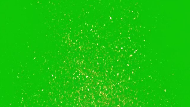 Golden glitter particles scattered on bright green background