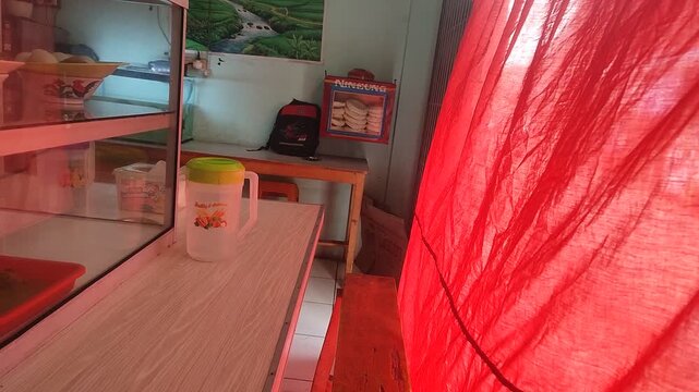 Documentary footage of warung tegal in Indonesia during Ramadan. Red curtain used to respect fasting customers. 