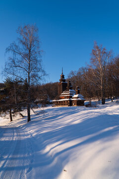 Ukrainian village. Seasonal landscape. Winter view with old wooden church