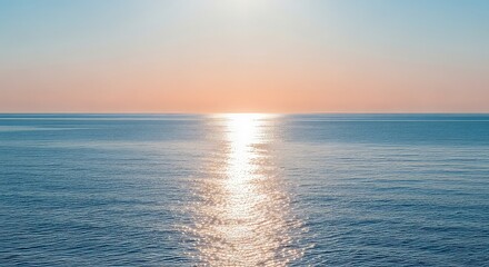 Obraz premium Serene ocean landscape at sunrise with calm waters reflecting vibrant colors of the sky and gentle morning light