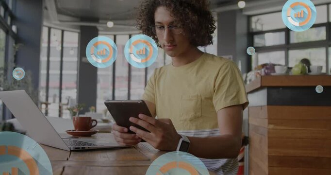 Animation of graph icon in circles over man scrolling on digital tablet in cafes