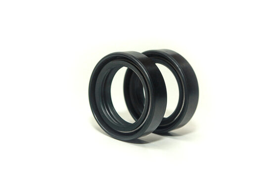 rubber oil seals featuring a garter spring designed to maintain constant pressure on the rotating shaft.