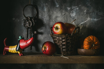 Apples and a small pumpkin on a shelf in the pantry
