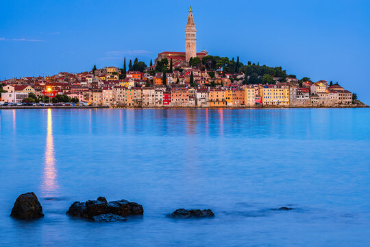 Coastline of Adriatic sea and The bell tower of Church of St. Euphemia and the old city of Rovinj, Istria, Croatia in a blue hour twilight dawn. 
