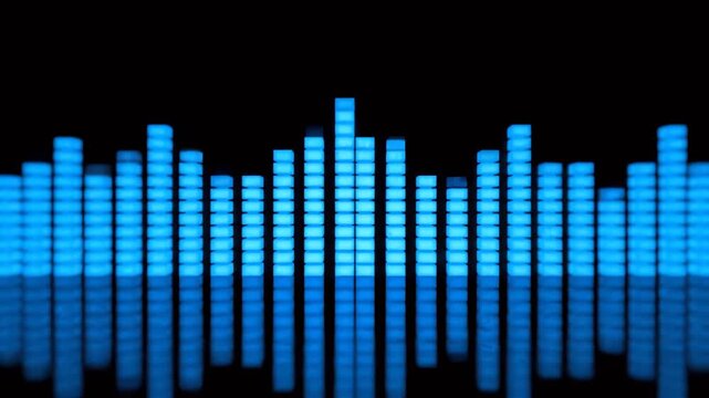 Audio Equalizer Bars Pulsing and Flashing on a Reflective Black Background Representing Sound Waves