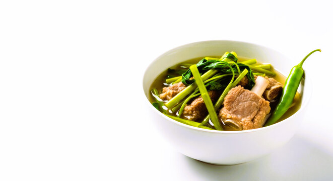 filipini sinigang soup,  Beef soup with green onions and vegetables in white bowl , local flavor 