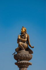 Fototapeta premium Golden Garuda Statue on Pillar at Patan Durbar Square Nepal with Blue Sky Copy Space