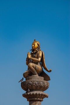Golden Garuda Statue on Pillar at Patan Durbar Square Nepal with Blue Sky Copy Space