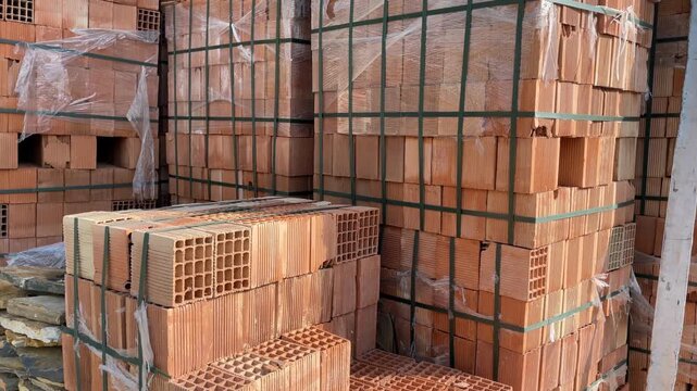 Construction bricks stacked at a site with various shapes and textures visible