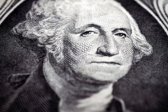 Macro close up of United States one dollar bill. Selective focus on eyes of George Washington. Extreme macro. Shallow depth of field.