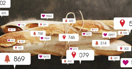 Displaying three crusty baguettes tied with twine on dark board, showing heart, pin, bell badges