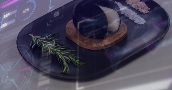 Showing black oval platter on table holding glossy dome on coaster, rosemary white or pink salts HUD