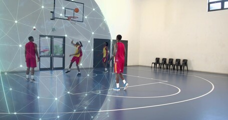 Obraz premium Shooting basketball player with team in red jerseys training in gym by hoop, with network graphic