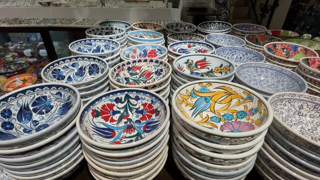 Colorful ceramic bowls with intricate patterns stacked in a shop, perfect for art background