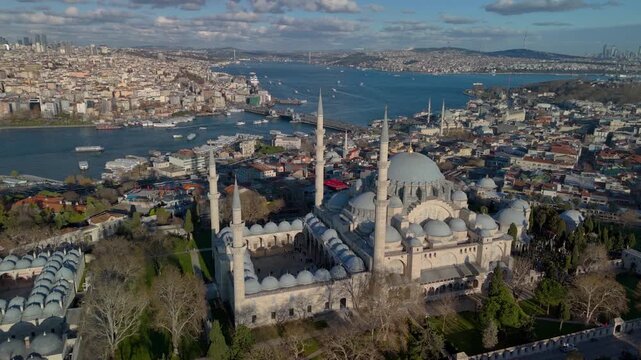 Aerial drone view of the historic Golden Horn in Istanbul, showing the Suleymaniye Mosque, Galata Bridge and the Bosphorus. Galata Tower and Taksim Square in the distance.