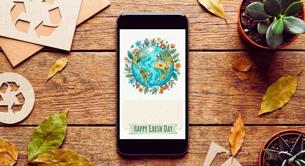Smartphone displaying Happy Earth Day illustration with recycling symbols and plants on wooden table.