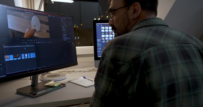 Video Editing Workflow: A dedicated individual meticulously edits a video on a dual-screen setup, showcasing a blend of technology and the art of visual storytelling.