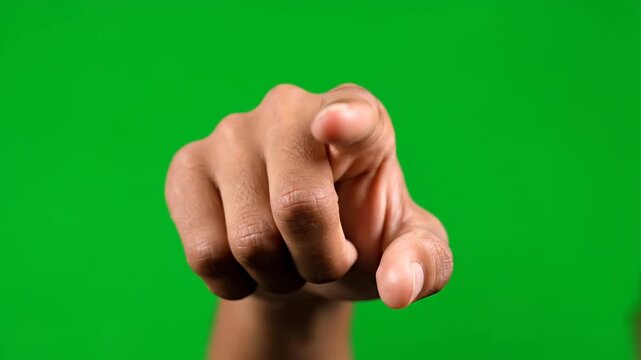 A hand pointing directly at the camera in a 4K VIDEO shot against a neutral background