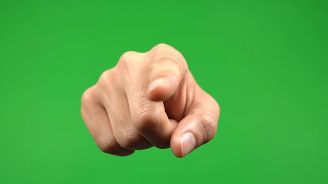 A close-up shot of a hand gesturing in front of a green screen VIDEO footage