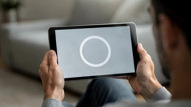 Medium shot of a person reviewing a video preview on a tablet the screen displaying a timelimited viewing countdown while the surroundings softly fade out of focus.