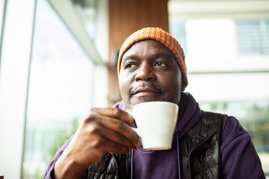 Middle-aged man enjoying coffee in cafe