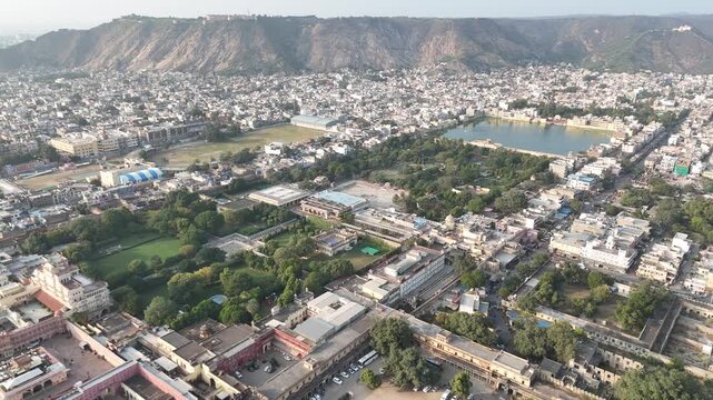Drone flight over Jaipur toward Nahargarh Fort with Tal Katora Lake Rajasthan India