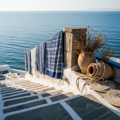 Serene Greek patio with blue towel, vase, and sea view