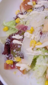 Closeup chef ipresenting delicious caesar salad on camera. slow motion. High quality FullHD footage